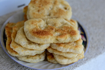 Traditional Bulgarian home made deep fried  patties  covered with sugar  оn rustic backgroud.Mekitsa or Mekica,  on wooden  rustic  background. Made of kneaded dough that is deep fried 