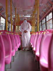 Person in Protective Suit on a Bus