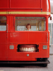 Red Bus with Teeth and Smiling Woman