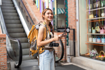Traveler Using Smartphone While Exploring City Streets