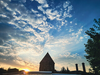 The silhouette of Erzurum historical Twin Minaret Madrasa at sunset of Anatolian architecture cloudy sky.