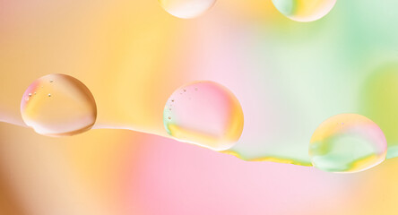 Macro Liquid Drops with Colorful Pastel Gradient. Abstract macro image of liquid drops with vibrant pastel colors blending into a smooth gradient background.