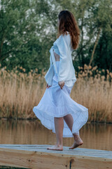 Her movements are light and graceful, as if she is merging with the surrounding nature.