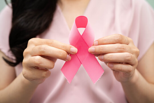 Asian woman with pink ribbon, World Breast Cancer Day at October. - Powered by Adobe