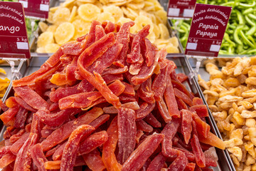 Red dried fruits of papaya and other offered at a market stall