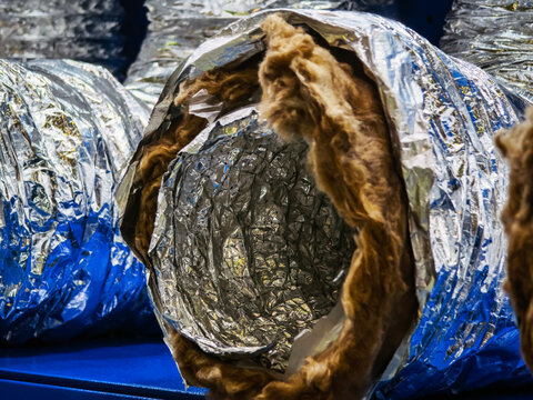 Insulated ducting materials arranged neatly in a storage facility showcasing construction supplies