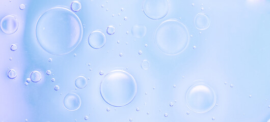 Light Blue Macro Liquid Bubbles. Macro photo of light blue liquid bubbles with soft gradients and transparent textures. Banner