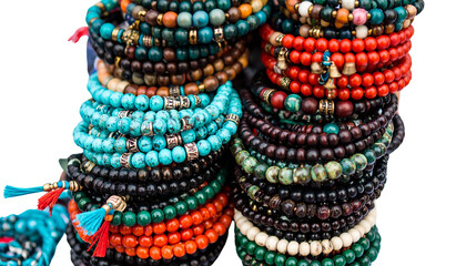 Stack of beaded bracelets in boho style with charms, isolated on transparent background