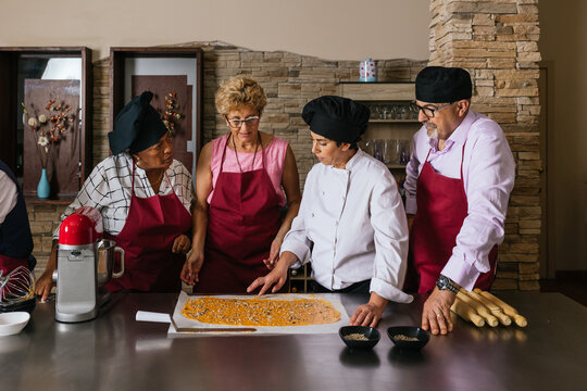 Chef teaching students how to prepare food in cooking class