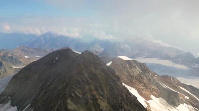 Experience the breathtaking views from the summit of Wildspitze, Austria's second highest mountain, showcasing stunning landscapes of the Otztal Alps and surrounding glaciers.