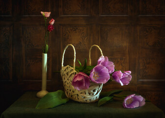 A beautiful bouquet of tulips in a white wicker basket.
