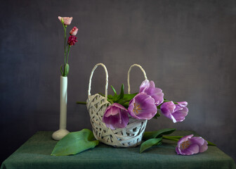 A beautiful bouquet of tulips in a white wicker basket.