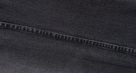 texture of black jeans denim fabric with seam background	
