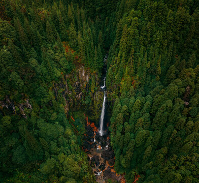 Aerial view of the Cascata das Lombadas plummets through a vibrant tapestry of verdant forest, a hidden gem unveiled from above, Concei&Atilde;&sect;&Atilde;&pound;o, Concei&Atilde;&sect;&Atilde;&pound;o, Portugal.