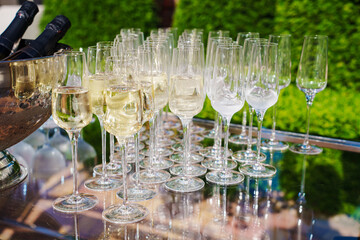 Elegant champagne glasses arranged at an outdoor celebration in the afternoon