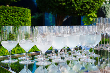 Clear glasses with refreshing drinks at an afternoon outdoor event