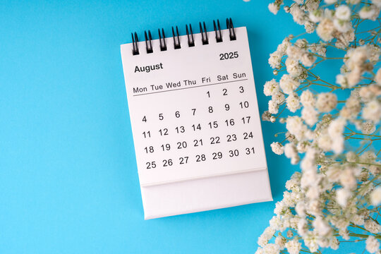 Top view of August 2025 Desk calendar on blue background