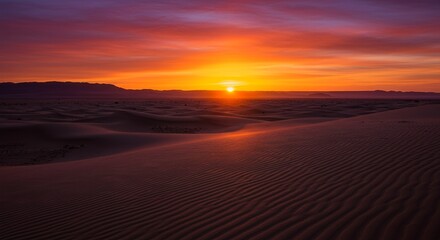 Fototapeta premium Desert landscape under a vibrant sunrise rippled sand foreground mountain silhouette against the colorful sky