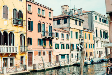 Colorful buildings lining a canal in venice, italy, are reflecting in the water