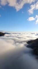 Fototapeta premium Stunning Aerial View of Mountains Above Cloudscape