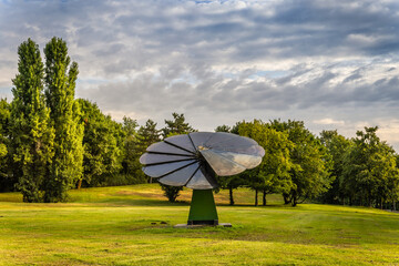 Rotating solar panel in flower shape in city park. Photovoltaic, alternative electricity source