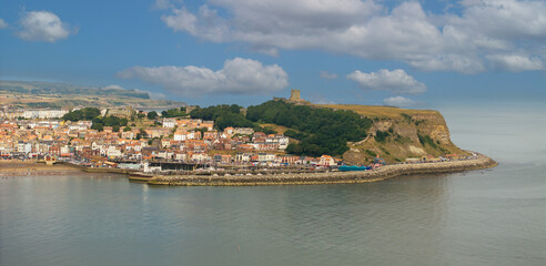 Aerial photo of Scarborough seafront and castle. Scarborough is a seaside town and civil parish in the district and county of North Yorkshire, England. With a population of 61,749