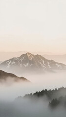 Snowy mountain peaks emerging from misty valley at dawn