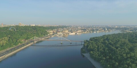 Fototapeta premium Wide river in city with bridge. Cityscape architecture