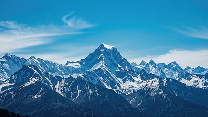 Fototapeta premium Snow-covered peaks beneath a clear blue sky in a natural landscape