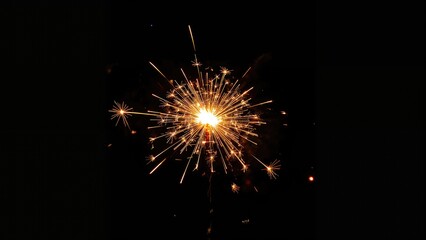 Fototapeta premium Bright orange flaming festive sparkler after sunset