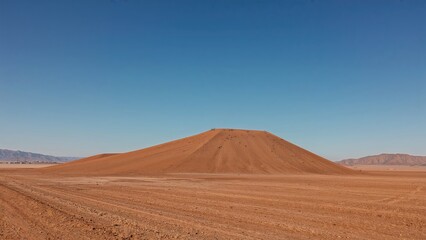 Fototapeta premium Lonely hill standing in a dry mountain valley