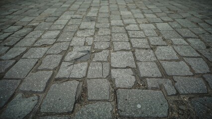 Fototapeta premium A pattern of grey paving blocks forms the square's floor.