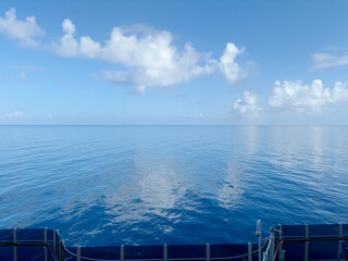 Minimalist view of vibrant blue sky and sea creating a serene, textured background, with a sleek...