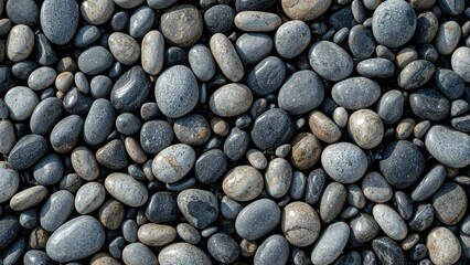 Texture background featuring polished round rocks, showcasing wet dark and dry gray pebbles