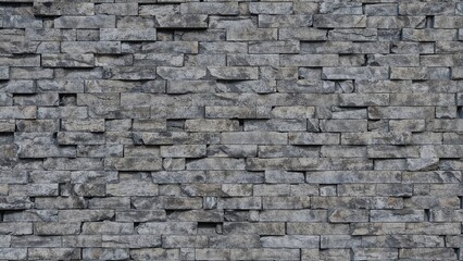 Obraz premium Gray textured brick wall featuring rough stone patterns