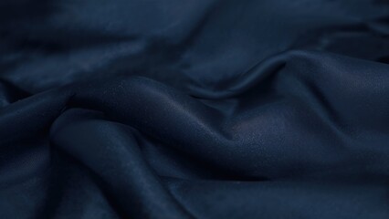 Smooth layers of dark, silky material drift softly, their faint wrinkles and sheer edges crafting a peaceful visual cadence.