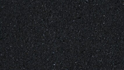 The surface looks coarse with a dark gray to black shade, resembling tightly packed stones or gravel as seen in asphalt paving.