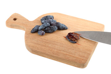 Halved honeysuckle berry on a cutting board.