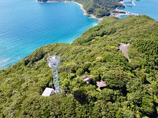 Drone aerial panorama from Jodake Observatory on Naru Island, Goto Islands, Nagasaki, Japan &ndash; vibrant summer coastline, fishing ports, and forested hills stretching to the horizon.