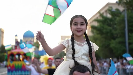 joyful young girl with braided hair waves flag while sitting on man's shoulders during vibrant outdoor celebration. national pride, cultural event. uzbekistan independence day, parade in tashkent,