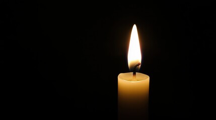 Single White Candle Flame Glowing in Darkness