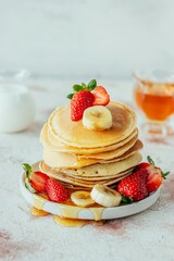 Stack of Pancakes with Strawberries, Bananas, and Syrup – Delicious Breakfast Concept