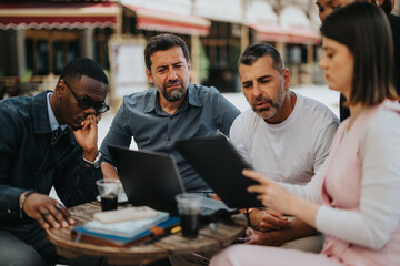 A diverse group of individuals engaged in a collaborative business meeting at an outdoor cafe,...