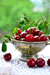 A bowl of fresh sweet cherries with leaves