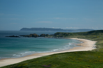 Scenic coastal view of the West Irish coastline, Atlantic side with sandy beach, blue sea, and open skies