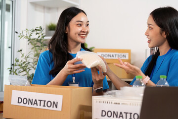 Volunteer spirit. Women discussing food donation while smiling and collaborating.