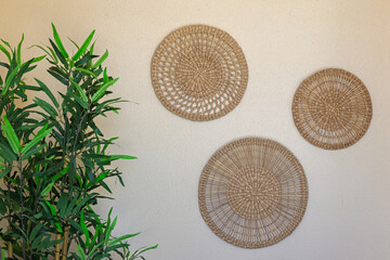 Rattan Wall Decor with Green Plant in Corner