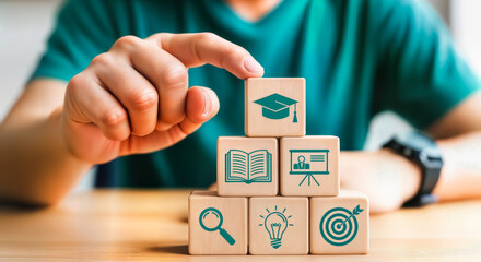 Stack of wooden blocks with icons representing education, learning, and success, symbolizing the building blocks of knowledge and personal development