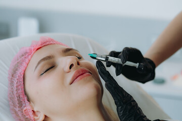 young woman getting an injection procedure in aesthetic clinic. Beauty treatment
