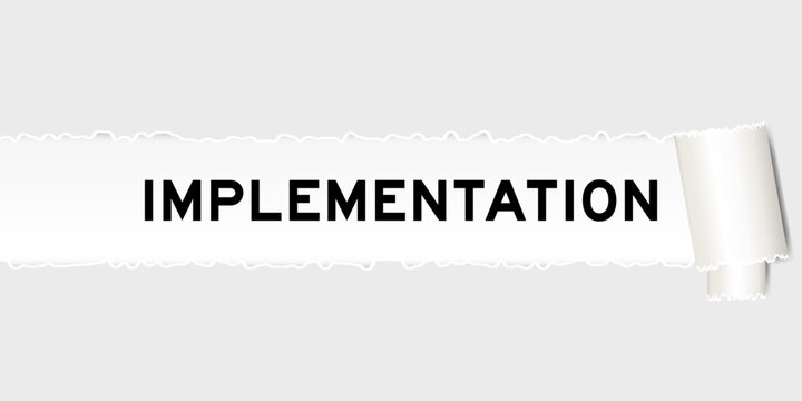 Ripped gray paper background that have word implementation under torn part
